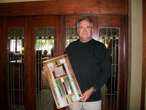 John Larsen posing with work.